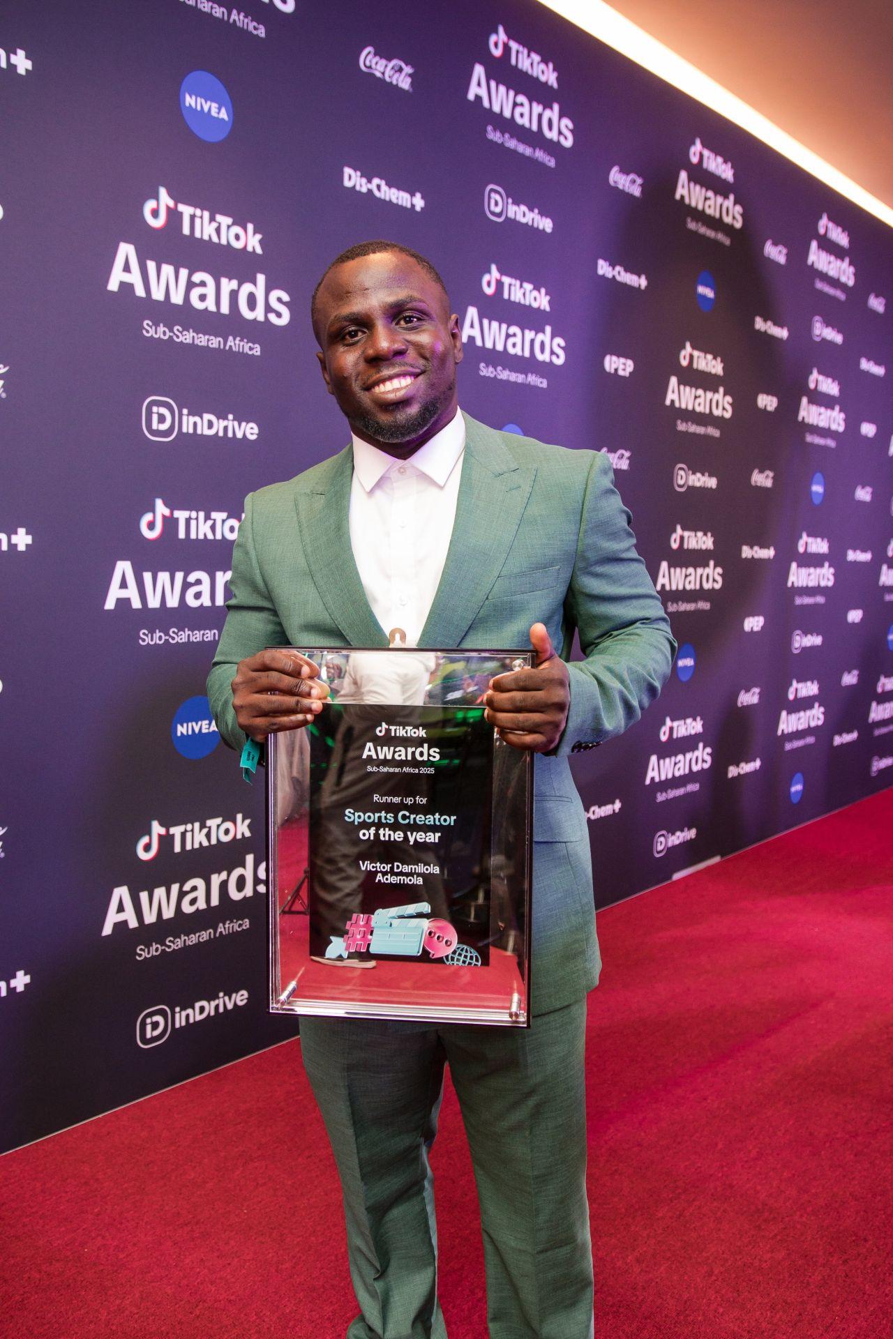 Dr. Victor Ademola holding his TikTok Awards Sub-Saharan Africa runner-up plaque